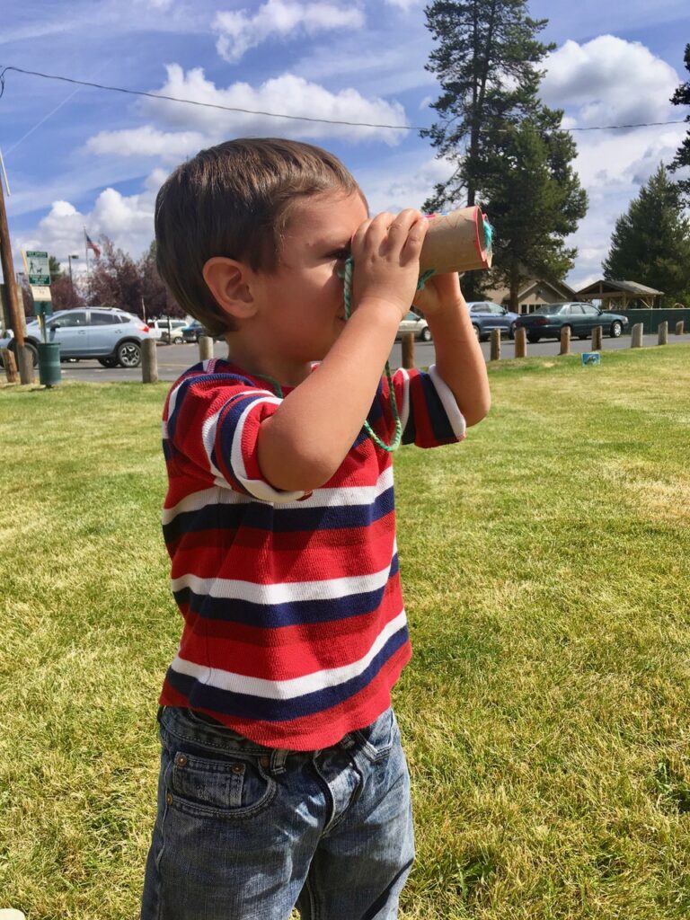 Young child using binoculars